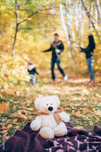 mom dad and baby in autumn park