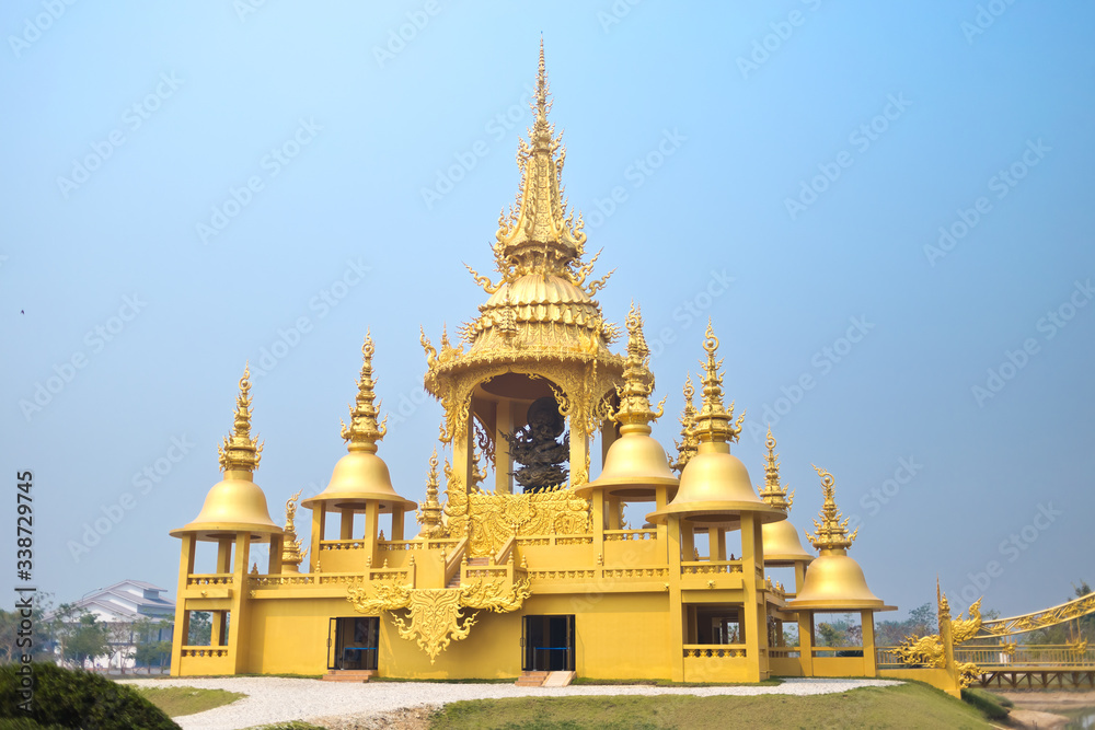 Unique Golden temple at the white temple and popular tourist attraction in Chiang Rai (known as Wat Rong Khun) in the North of Thailand