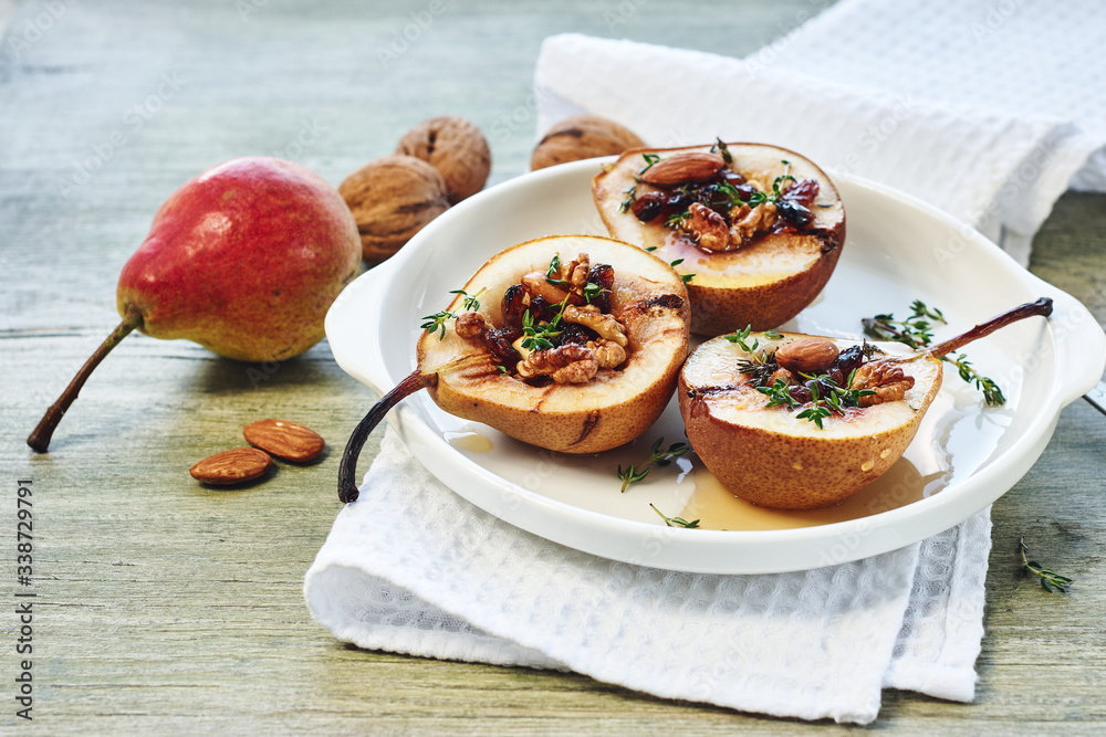 Baked pears with nuts, raisins, honey and cinnamon. Baked pears with nuts, raisins, honey and cinnamon.