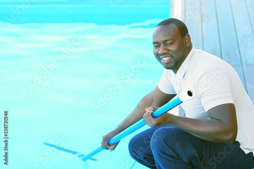 African Pool cleaner during his work. Cleaning robot for cleaning the botton of swimming pools. Automatic pool cleaners.