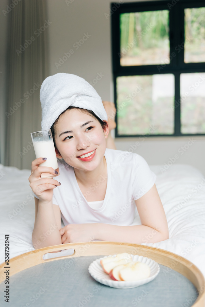 Young asian girls drink milk in bed Young asian girls drink milk in bed