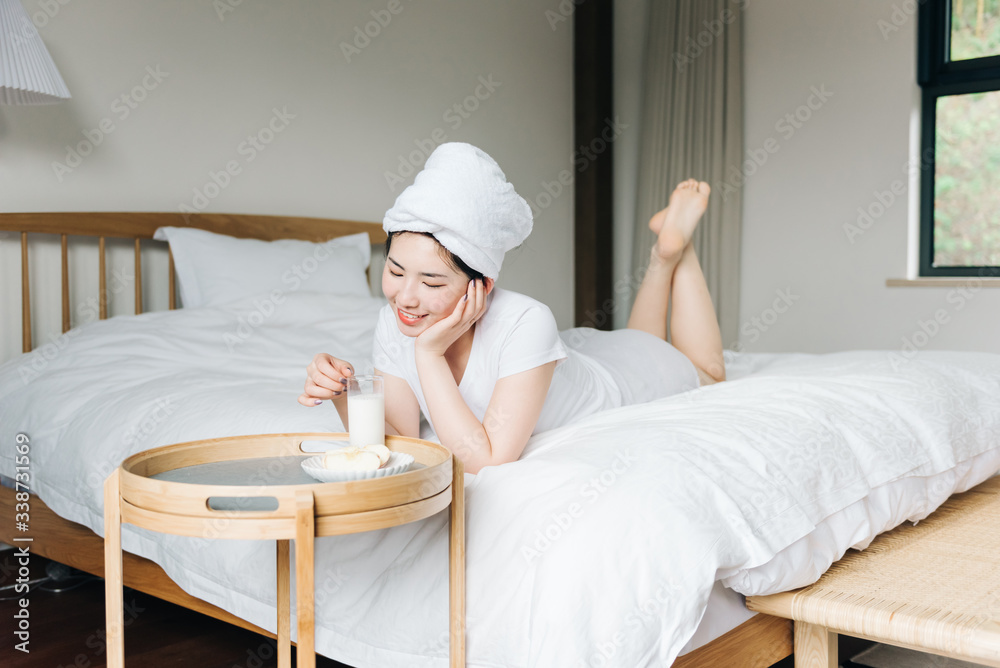 Young asian girls drink milk in bed Young asian girls drink milk in bed