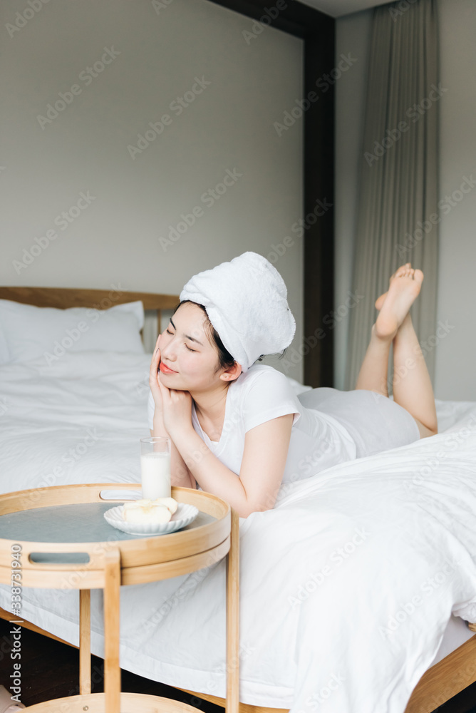 Young asian girls drink milk in bed Young asian girls drink milk in bed