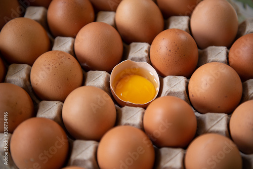 Chicken eggs and half broken egg with yolk, Eggs are scarce and expensive in the situation of the Covid 19 virus.