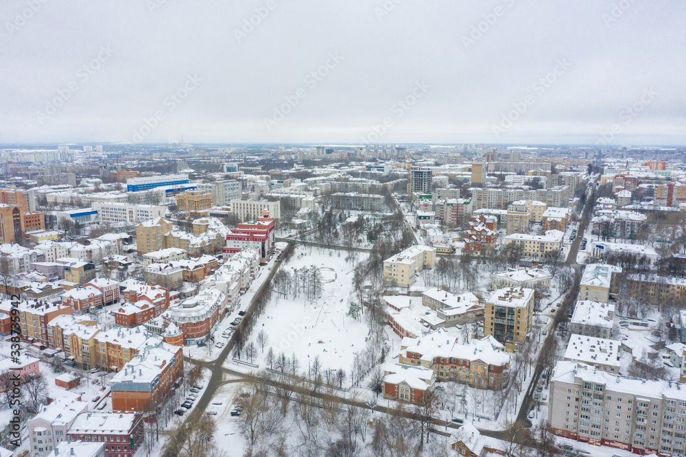 Panorama of the small town and Razderikhinsky ravine in the central part of the city of Kirov on a winter day from above. Russia from the drone.