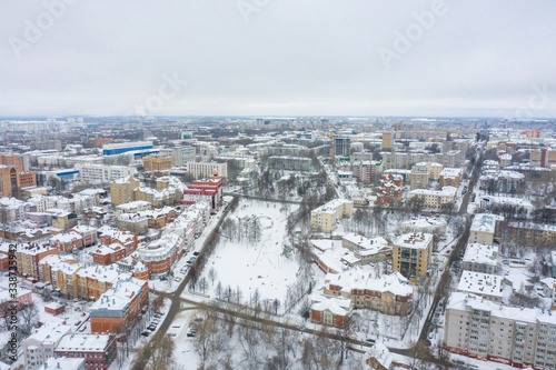 Panorama of the small town and Razderikhinsky ravine in the central part of the city of Kirov on a winter day from above. Russia from the drone. © miklyxa