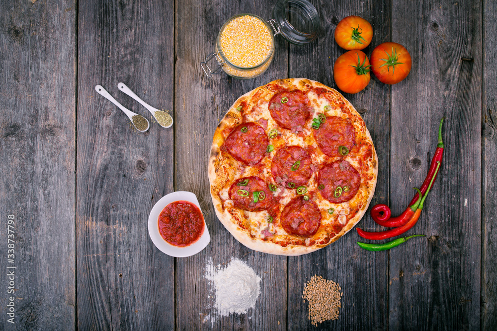 Styled Top View of Large Pepperoni Salami Pizza, Food Photography on wooden background table Styled Top View of Large Pepperoni Salami Pizza, Food Photography on wooden background table