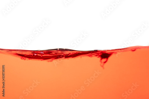 Red water splash and air bubbles on white background
