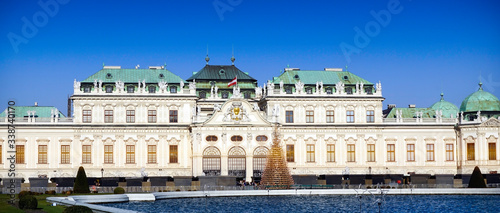 Belvedere palace historical building architecture elevation with pool foreground and blue sky background in Vienna, Austria, Europe
