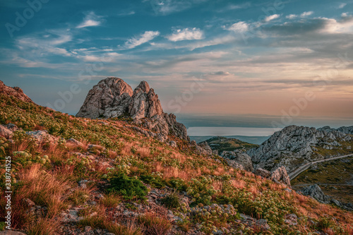 Landscape view of the mountain and old  road, Adriatic sea in the background. Tulo's Rafters, Velebit Nature Park, Croatia. photo