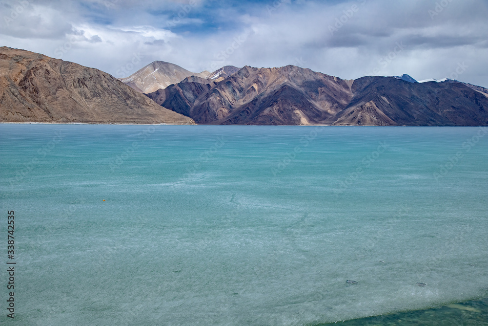 View landscape of Himalayas mountains and Frozen lake Pangong Tso high grassland lake while winter season for indian and tibetan and foreigner travelers travel visit at Leh Ladakh, India. View landscape of Himalayas mountains and Frozen lake Pangong Tso high grassland lake while winter season for indian and tibetan and foreigner travelers travel visit at Leh Ladakh, India.