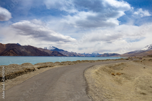 View landscape of Himalayas mountains and Frozen lake Pangong Tso high grassland lake while winter season for indian and tibetan and foreigner travelers travel visit at Leh Ladakh  India.