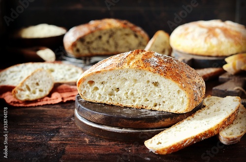 Homemade bread: corn, with sesame seeds and chia seeds on a dark wooden background. rustic
