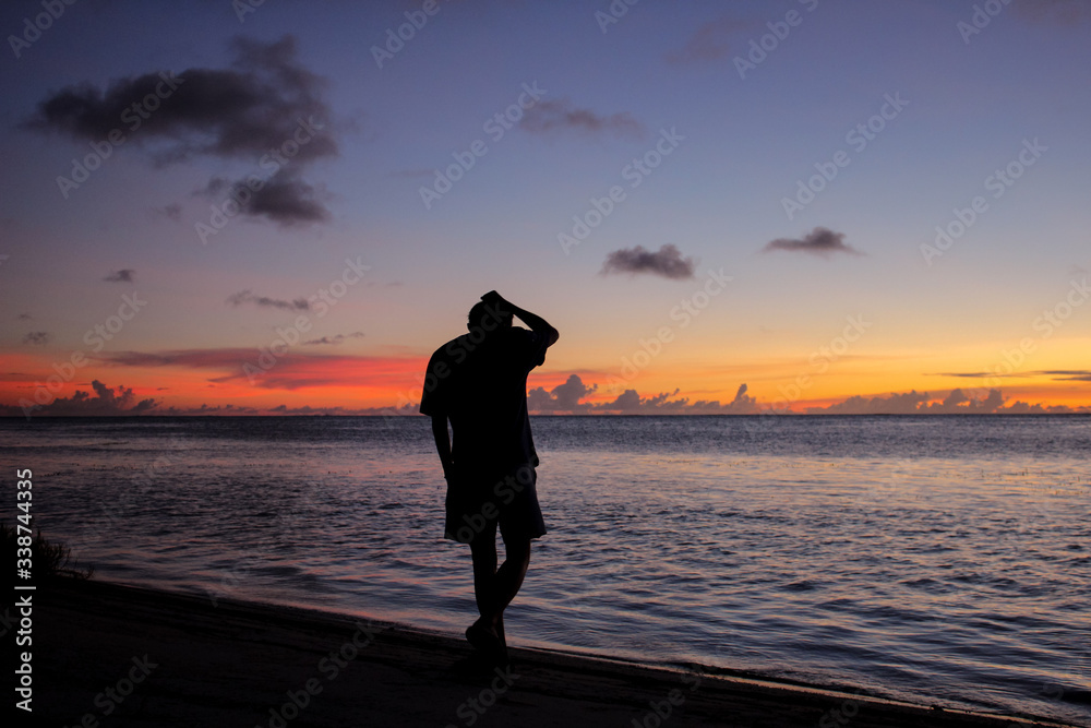 man standing silhouette sunset seascape on the tropical beach