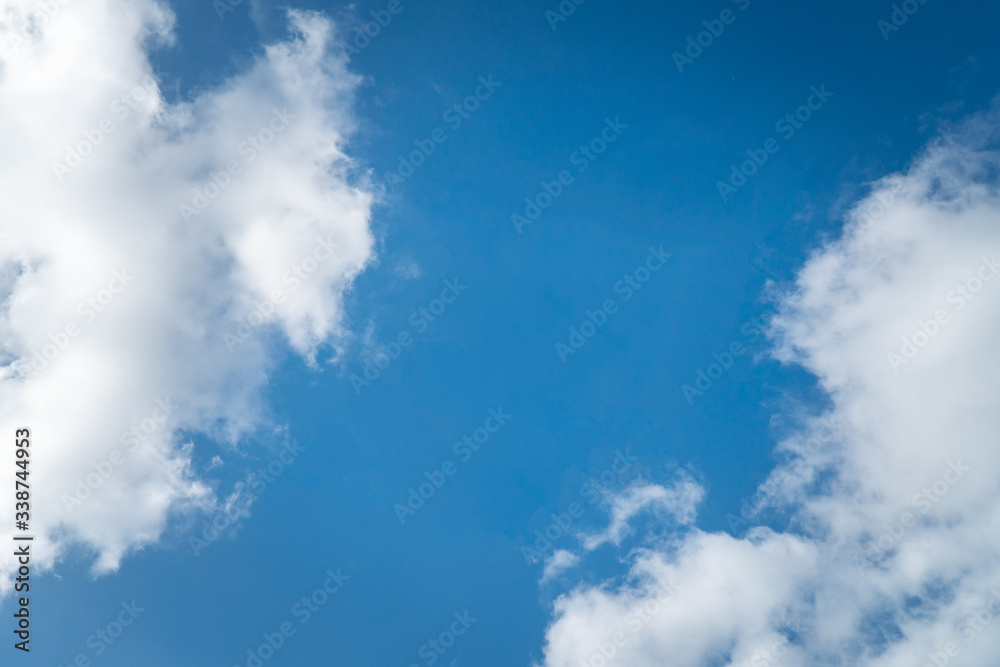 Obraz premium Background nature clear clean blue sky soft clouds beautiful dramatic cloudscape summer sun ray light presents beautiful day life after storm. use as overlay effect or frame with center copy space 