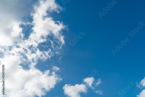 Background nature clear clean blue sky soft clouds beautiful dramatic cloudscape summer sun ray light presents beautiful day life after storm. use as overlay effect or frame with center copy space  
