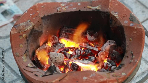 Stove charcoal.orange flames of coals in the grill / Charcoal stove burning.Brazier charcoal burning ready to grill in solid stove,feel cliam and warm at night. photo