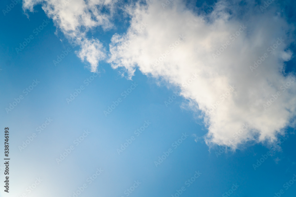 Background nature clear clean blue sky soft clouds beautiful dramatic cloudscape summer sun ray light presents beautiful day life after storm. use as overlay effect or frame with center copy space Background nature clear clean blue sky soft clouds beautiful dramatic cloudscape summer sun ray light presents beautiful day life after storm. use as overlay effect or frame with center copy space