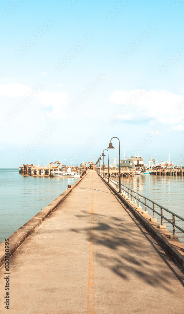 Bridge to the port on the popular tourist island - Exotic island of Koh Samui in Thailand - Sunny weather and calm sea in the bay - Bright filter