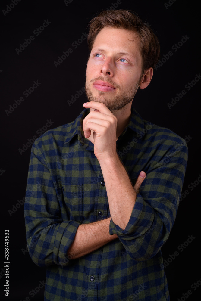 Portrait of bearded hipster man thinking and looking up Portrait of bearded hipster man thinking and looking up