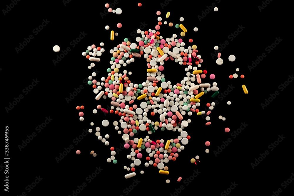 The ill effects of drugs.
Skull with colored pills on black background
