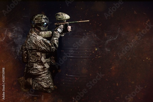 Paintball support player aiming behind the barrel 