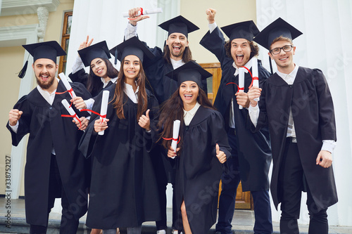A group of young fun graduates smiling