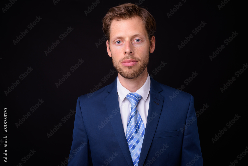 Face of bearded businessman in suit looking at camera Face of bearded businessman in suit looking at camera