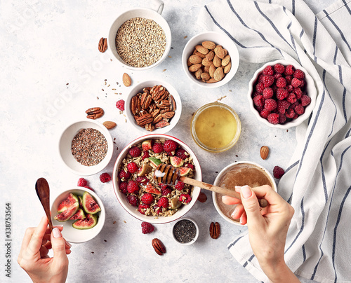 Healthy breakfast, oatmeal with raspberries, figs and nuts and seeds. The concept of a healthy lifestyle, diet. Top view