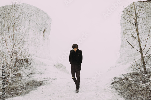 dramatic man portrait. emotions. fear. experiences. handsome guy model in the mountains. frame from the movie. CD cover. book cover
