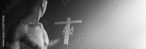 man holding a wooden cross