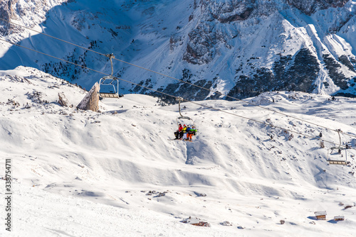 Snowy landscape in the Italian Alps - ski resort with many ski tracks and snowy tops. Italian Dolomites / Dolomiti 