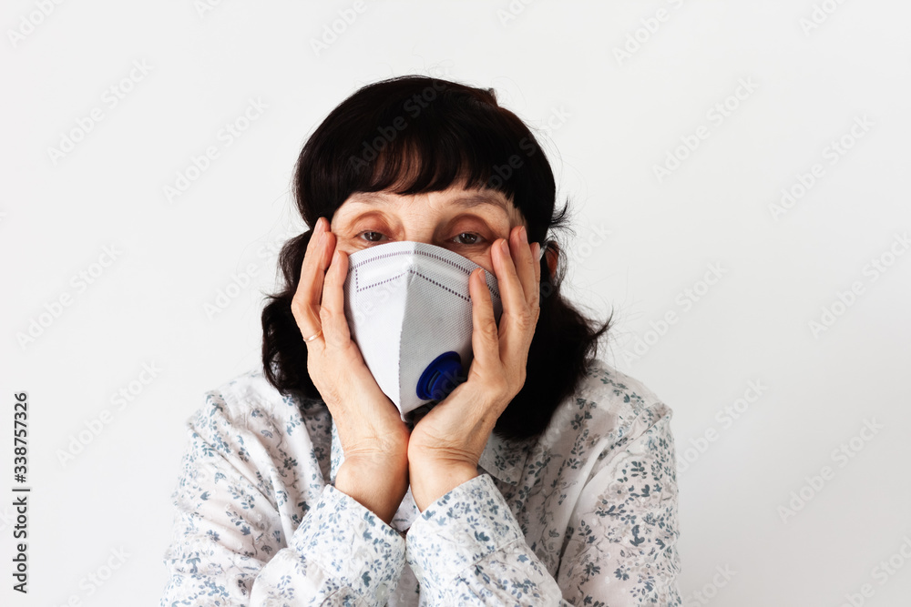 Coronavirus quarantine Covid-19 concept. Face of old sick woman wearing respirator mask for protect. Wuhan, China epidemic virus symptoms background. Coronavirus quarantine Covid-19 concept. Face of old sick woman wearing respirator mask for protect. Wuhan, China epidemic virus symptoms background.