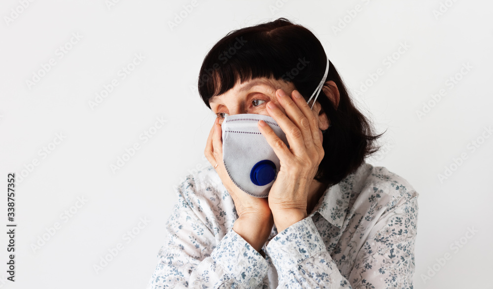 Coronavirus quarantine Covid-19 concept. Face of old sick woman wearing respirator mask for protect. Wuhan, China epidemic virus symptoms background. Coronavirus quarantine Covid-19 concept. Face of old sick woman wearing respirator mask for protect. Wuhan, China epidemic virus symptoms background.