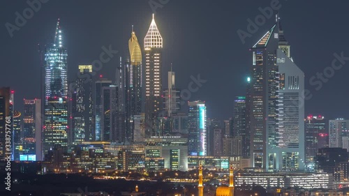 Wallpaper Mural Panorama of the modern arabic city with illuminated skyscrapers and mosque aerial timelapse in Financial centre, Dubai, United Arab Emirates at night Torontodigital.ca