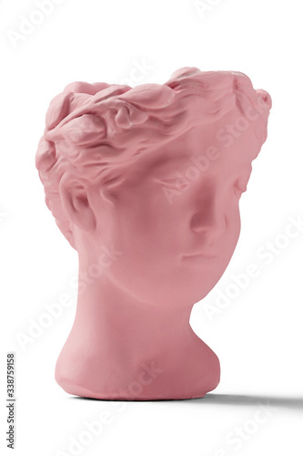 Subject shot of a pink ceramic flower pot made as an antique head. The garden-pot is isolated on the white background. 