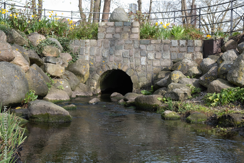 Fototapeta premium spillway made of granite and stone and running water