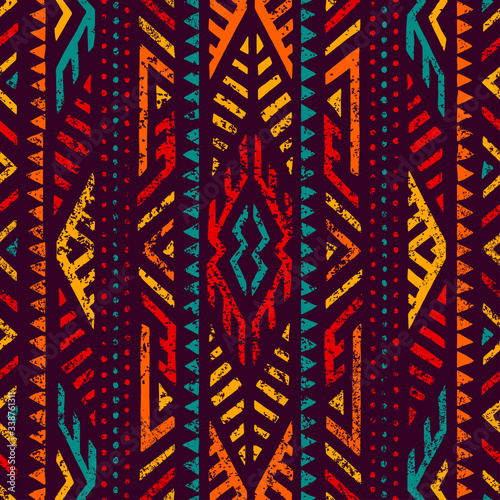 Seamless ethnic ornament. Aztec and tribal motifs. Ornament drawn by hand. Blue, purple, yellow, red and orange colors. Print for your textiles. Vector illustration.