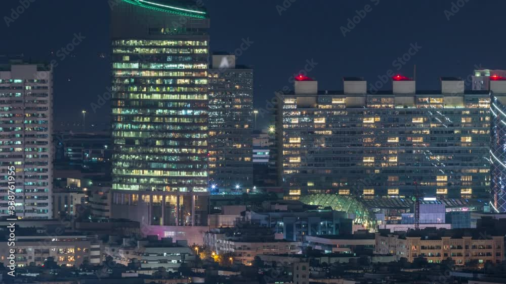 View of Dubai at night with illuminated windows in office skyscrapers and small attractive houses aerial timelapse near Dubai Creek, Dubai, United Arab Emirates View of Dubai at night with illuminated windows in office skyscrapers and small attractive houses aerial timelapse near Dubai Creek, Dubai, United Arab Emirates