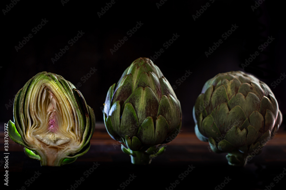 Obraz premium Two Whole and one Slice artichoke
