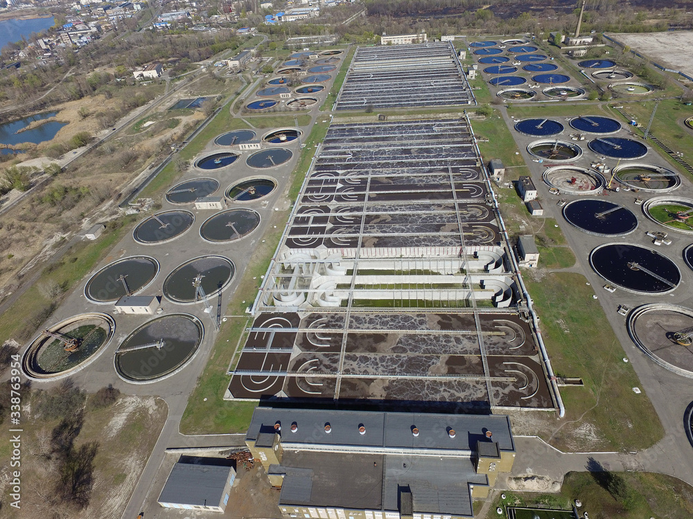 Aerial top view on sewage treatment plant with circular tanks in Kiev