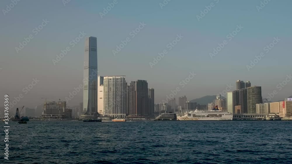 Day View on Hong Kong Kowloon District with passing boats Day View on Hong Kong Kowloon District with passing boats