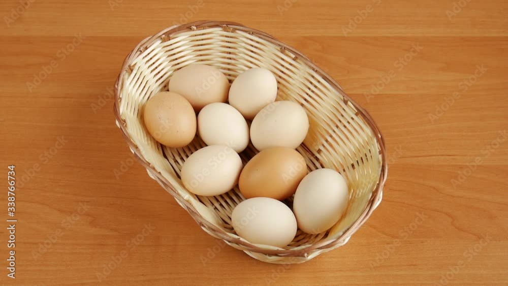 Eggs in a basket on table. 