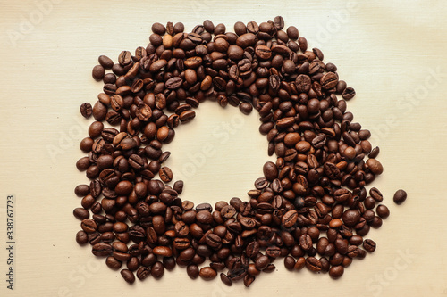 Coffee grains with space for text on brown paper background