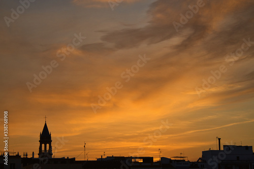 Black silhouette buildings on sunset