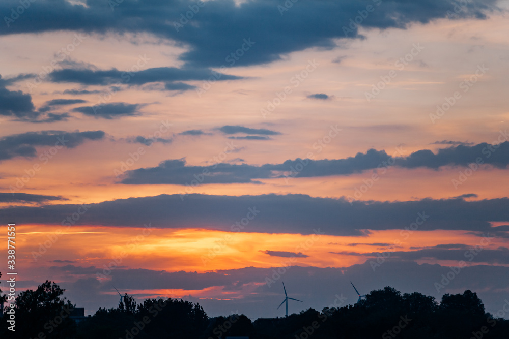 The sun at sunset behind the clouds. Beautiful sunset The sun at sunset behind the clouds. Beautiful sunset