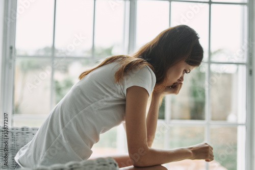 young woman sitting on window sill Free Download young woman sitting on window sill - GFXLoad