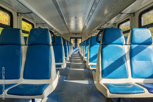 Blue seats in an electric train carriage without passengers