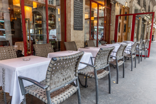 Empty tables in a european street cafe. Quarantine during the coronavirus pandemic. Sad mood.