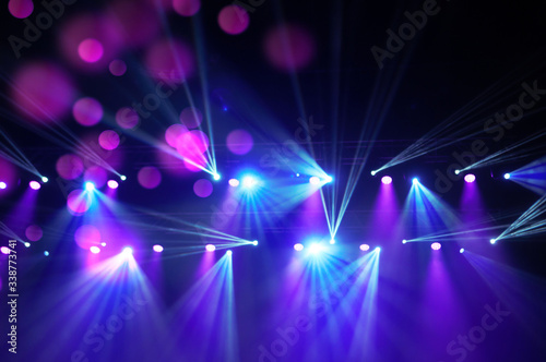 Stage lights on concert. Lighting equipment with multicolored beams